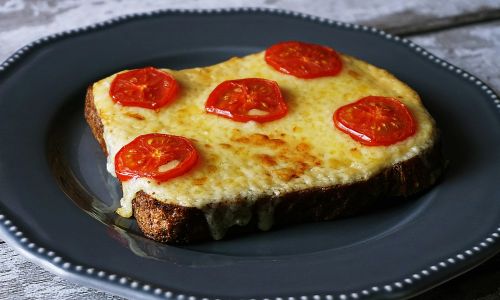 plate with melted cheese on toast