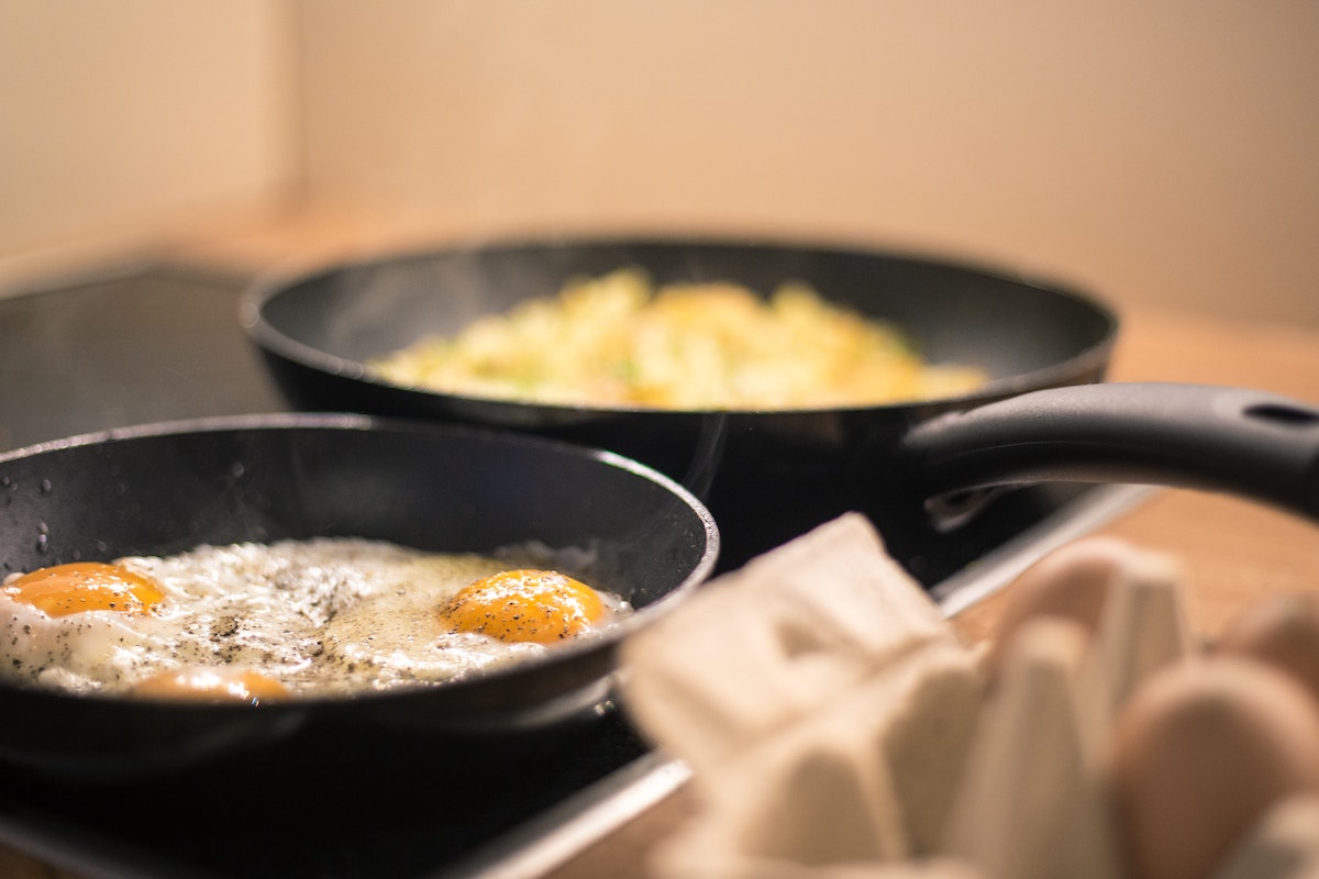pans with fried and scrambled eggs