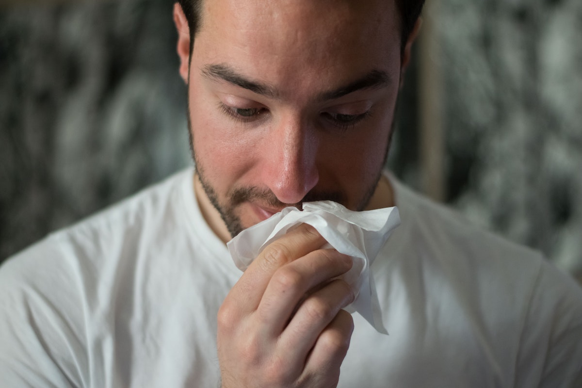 person blowing nose cheap hay fever tablets