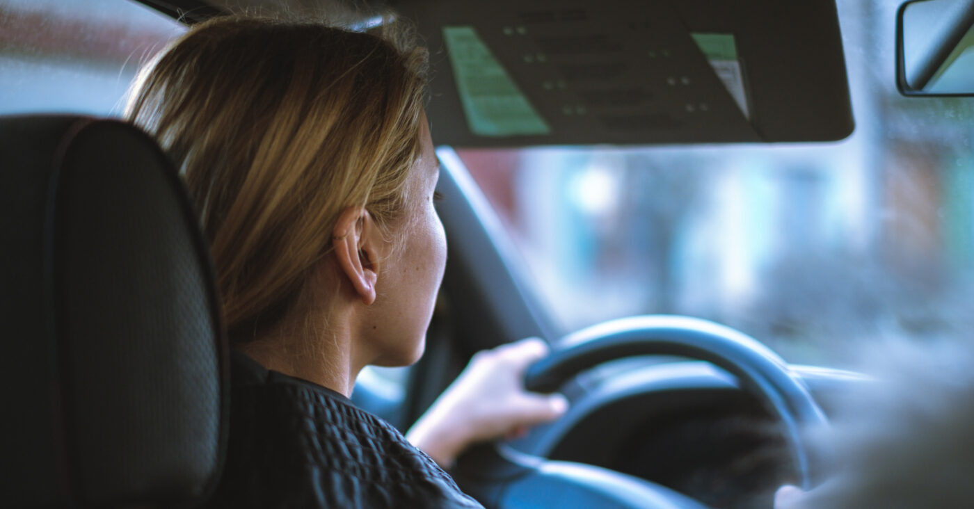 back of woman driving car. cheap first cars to insure article