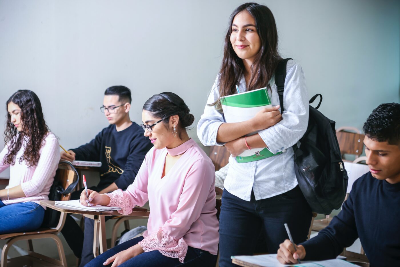 javier-trueba-iQPr1XkF5F0-unsplash.jpg Student at university class holding her books