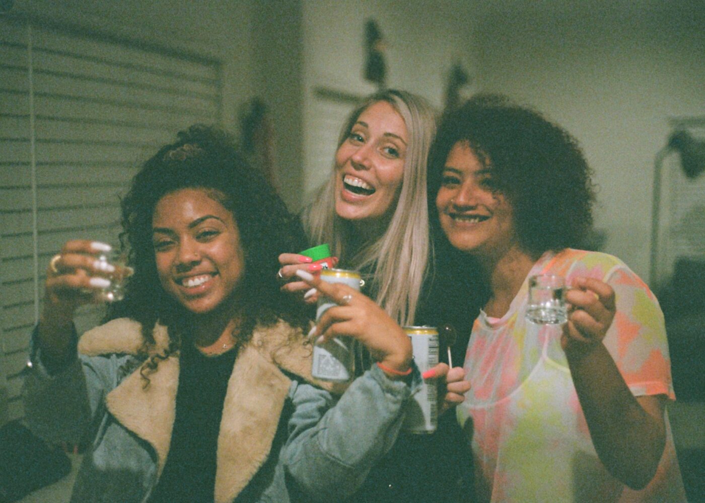Female students posing together with drinks during freshers' week