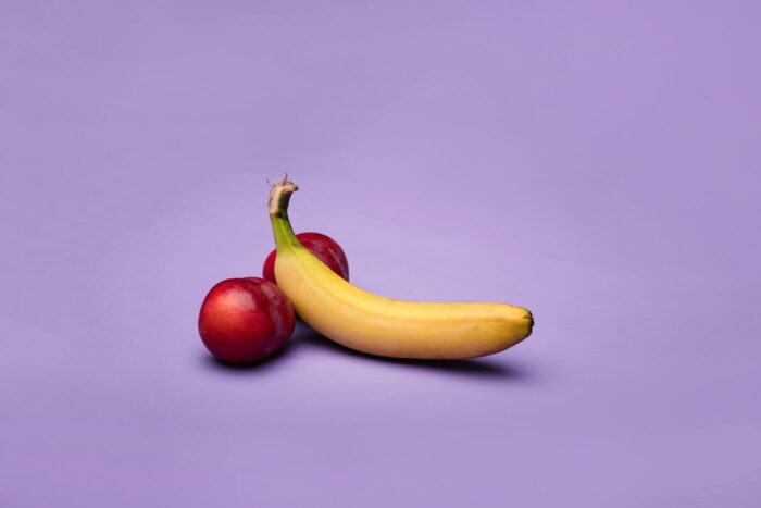 Apples and banana staged like male genitals. Itchy balls article