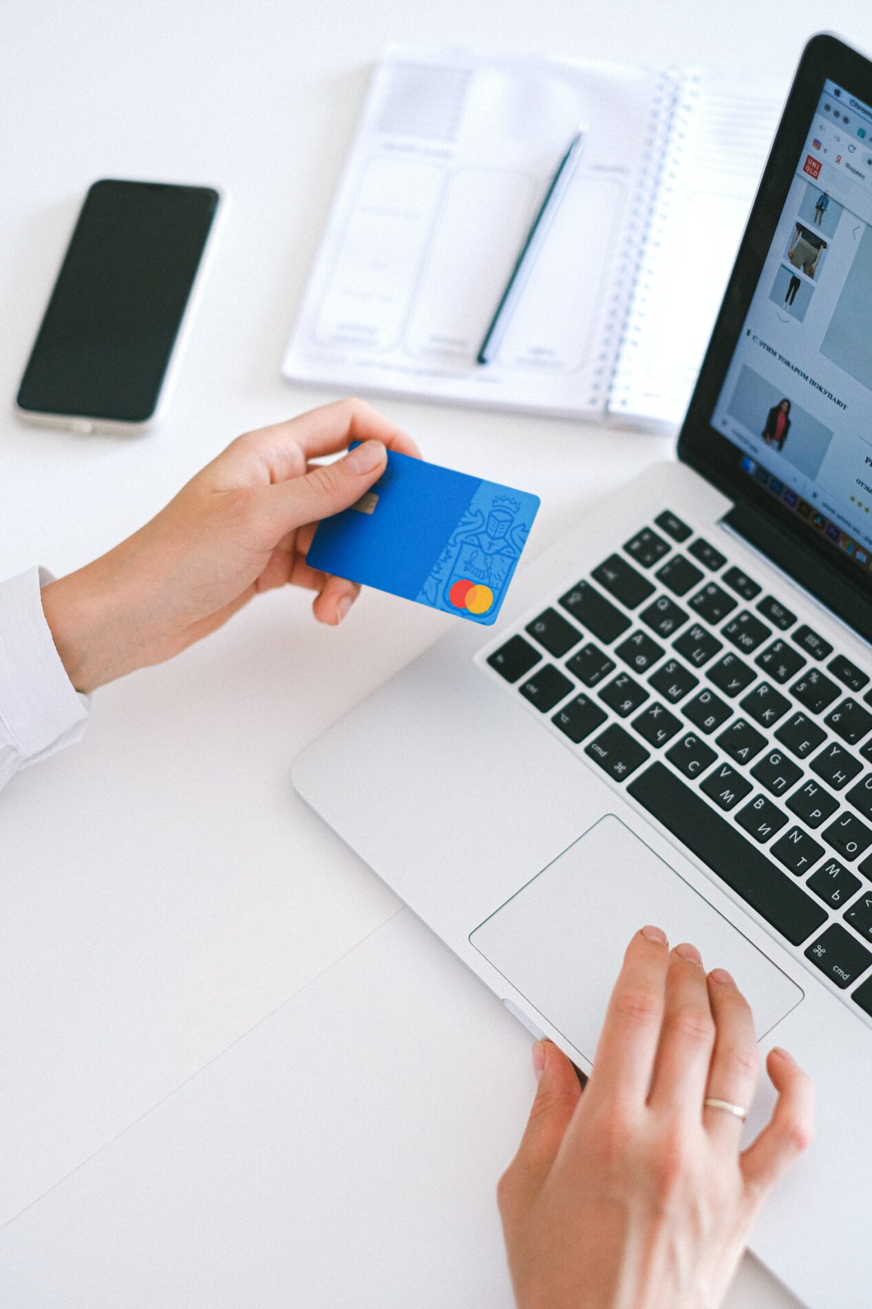 bank card held in front of laptop - minimum maintenance loan 