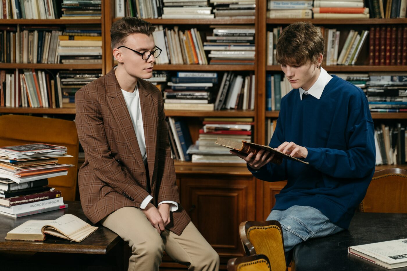 students talking in library - minimum maintenance loan