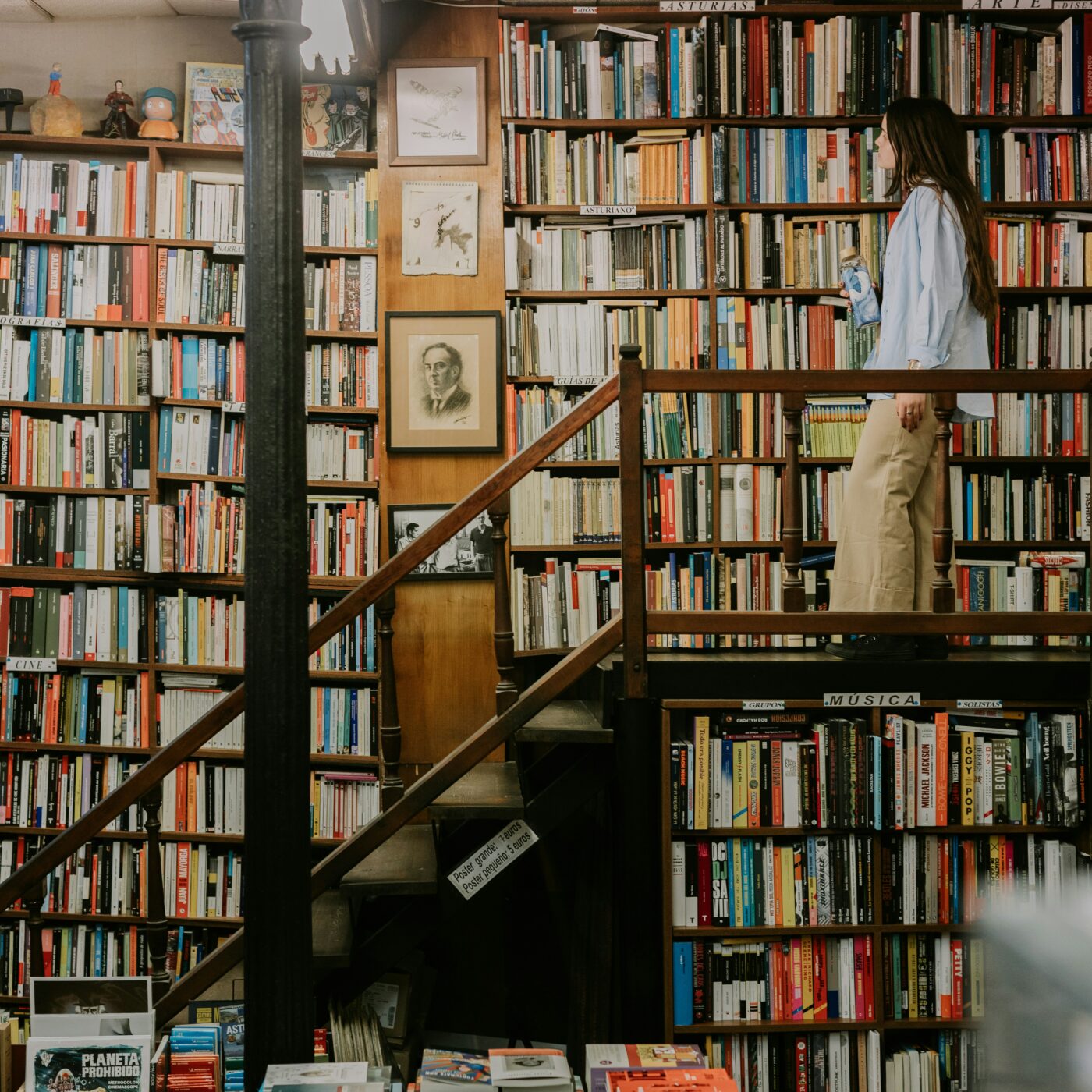 Woman browsing books on a shelf