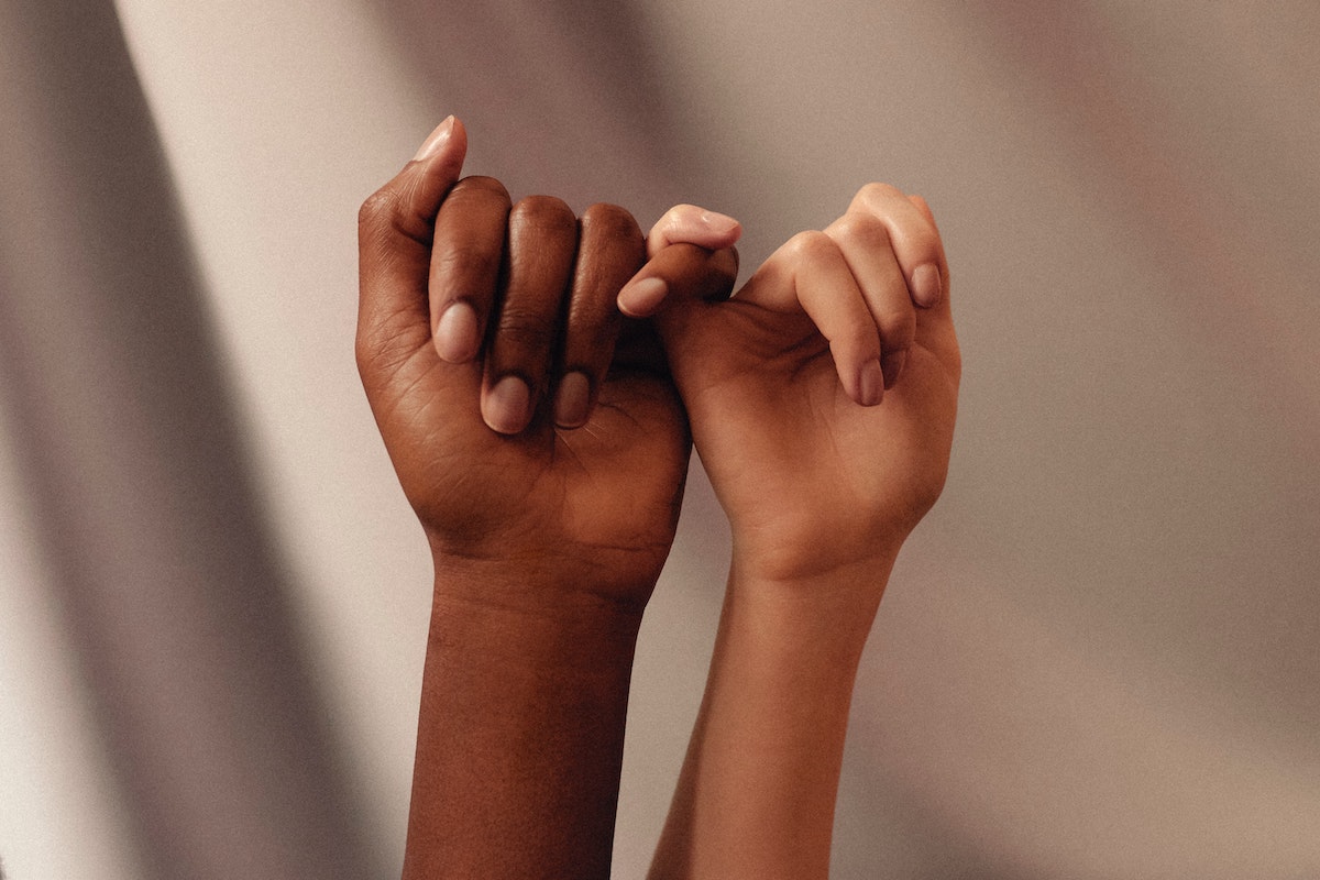 two people crossing pinky fingers