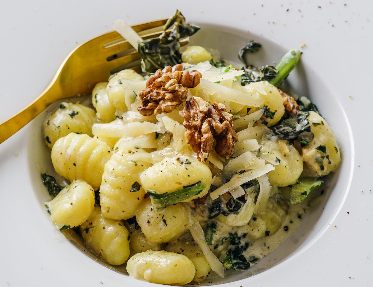 gnocchi dish with greens and walnuts and cheese - cheap student meals for one