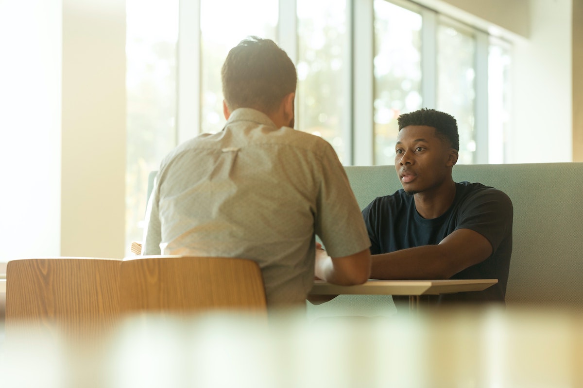 two people sitting at table for interview