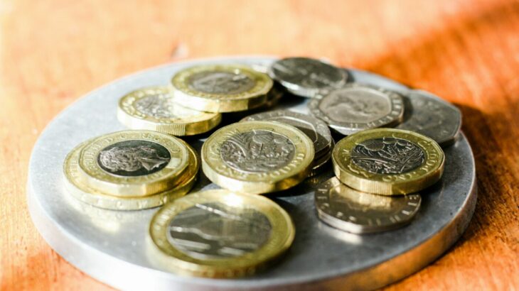 Pile of coins on a plate - student finance payment dates