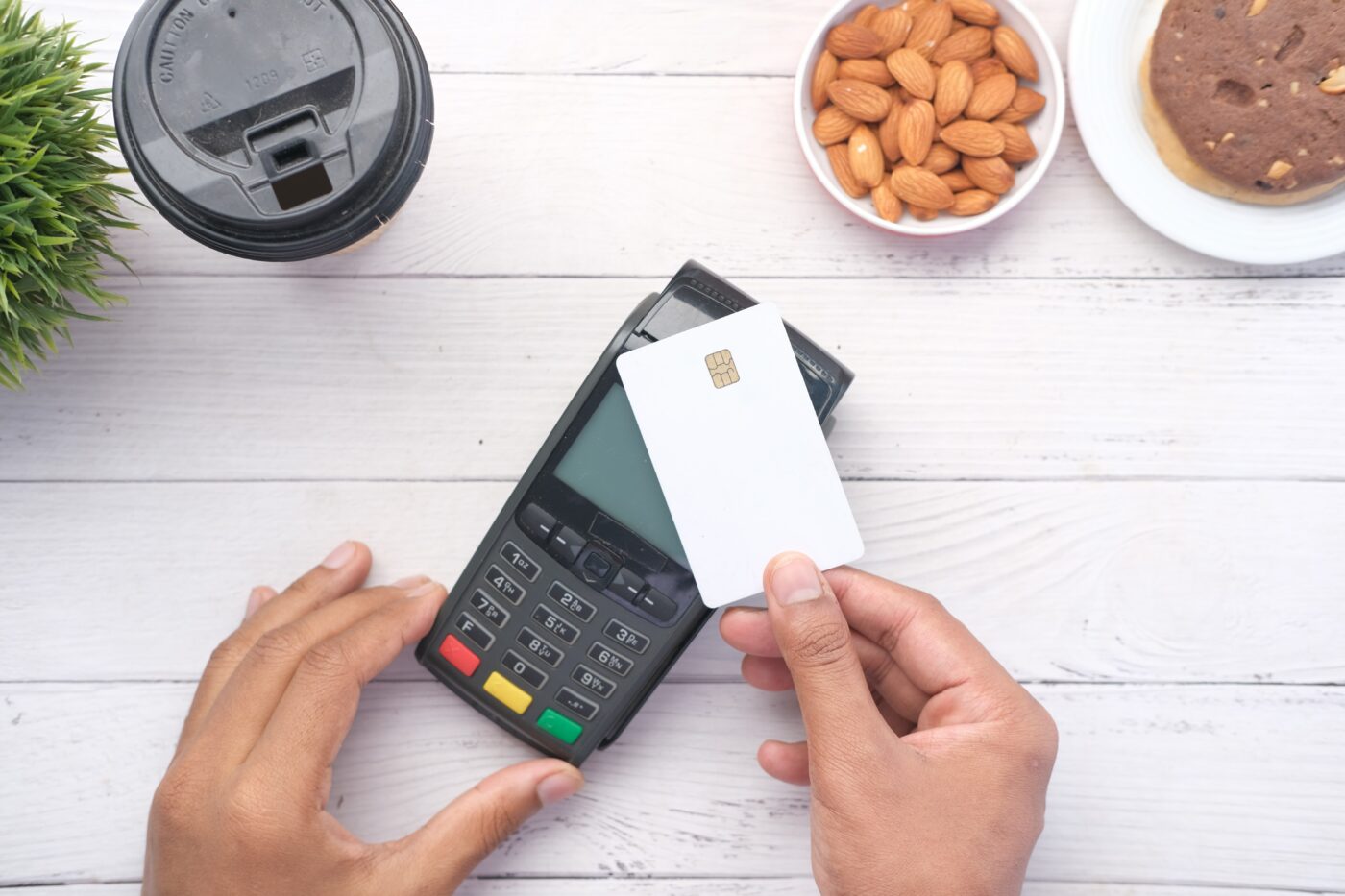 Person tapping their contactless credit card on a card machine